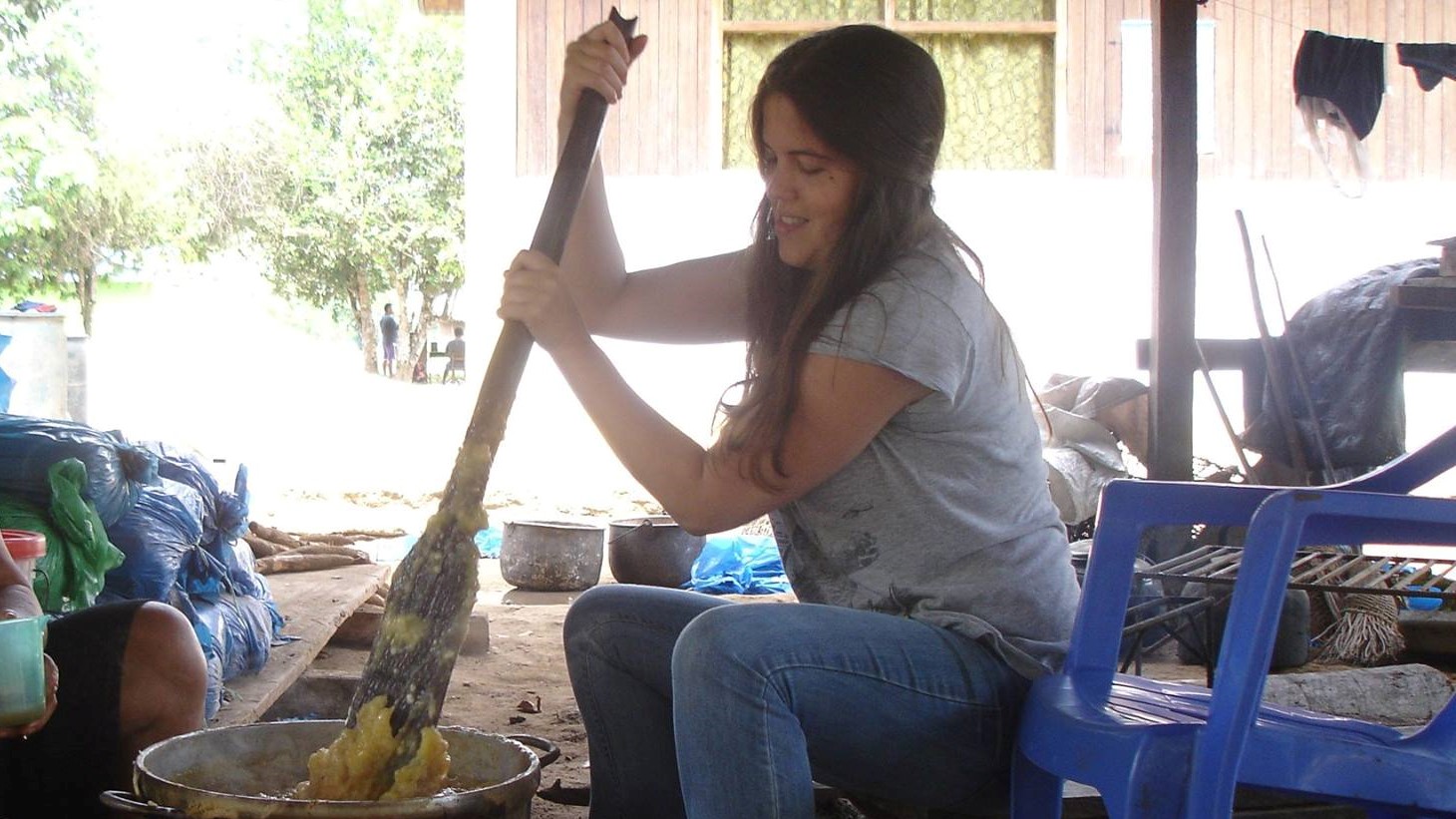 Kelsey mashes yuca to make masato